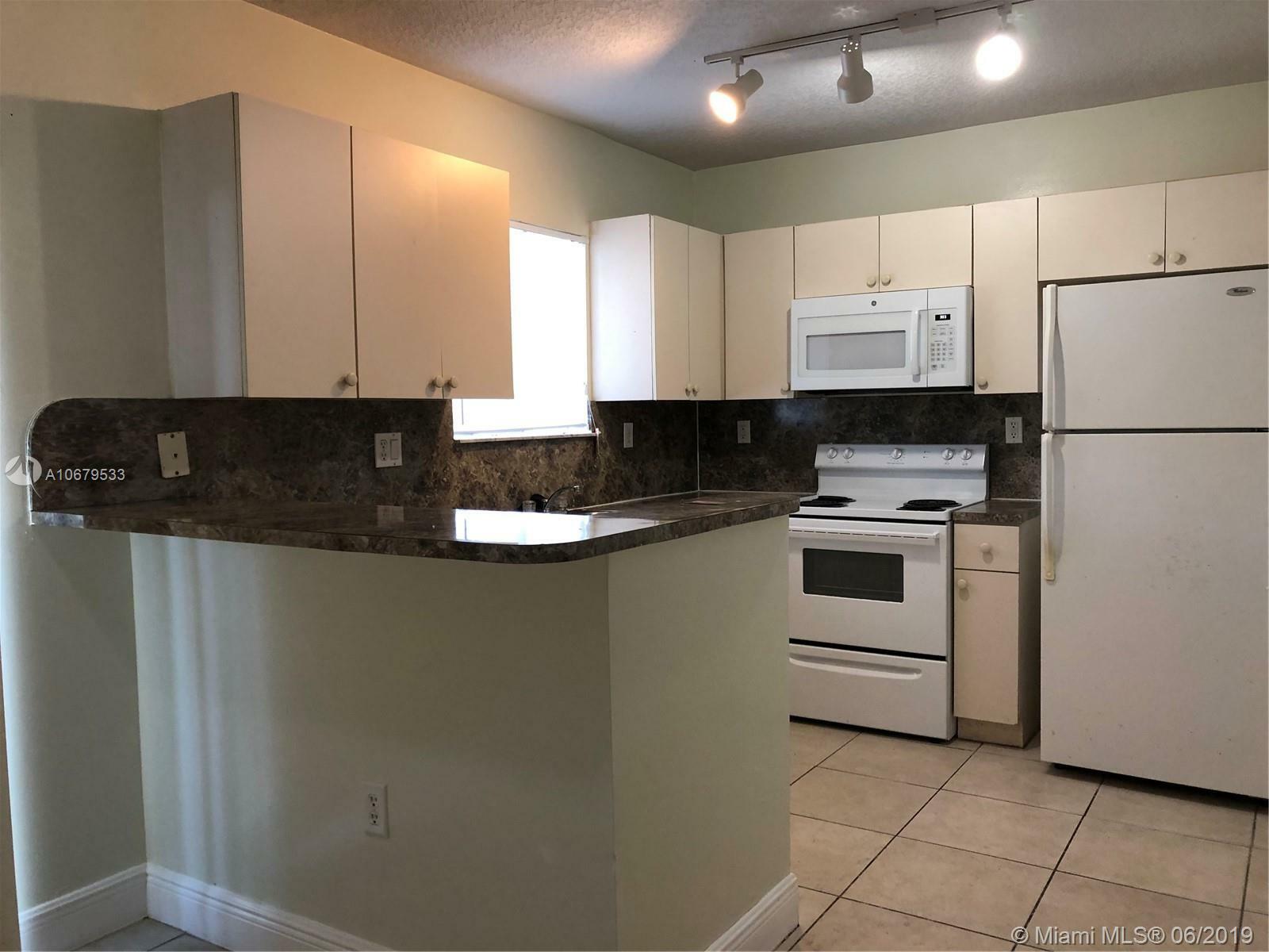 Property Photo:  980 NE 33rd Ter 104  FL 33033 