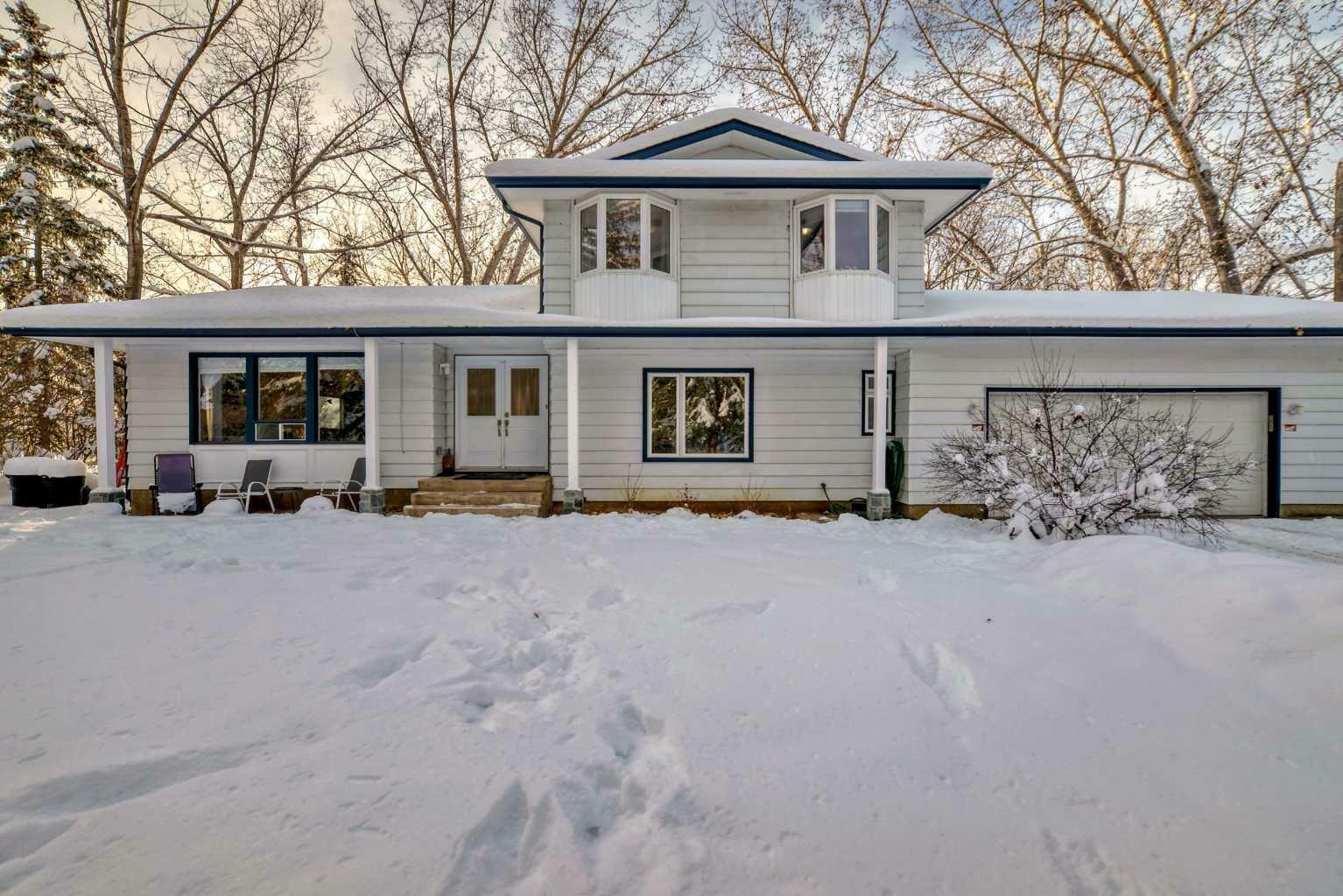 Property Photo:  322043 8 Street E  AB T1S 3L7 