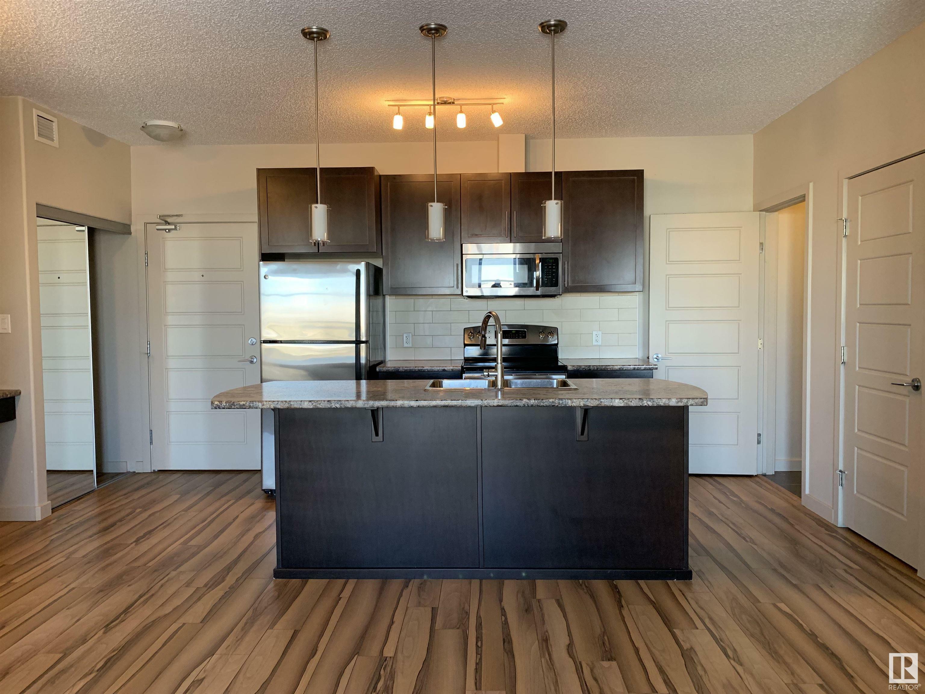 Property Photo: 1144 Adamson Drive SW 317 AB T6W 2X7