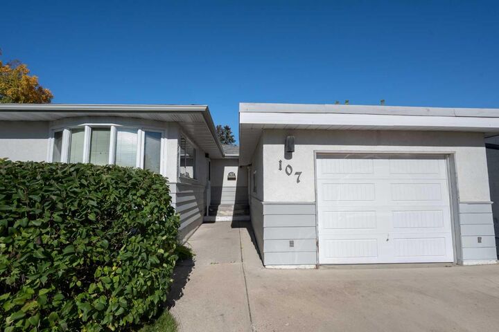 Property Photo: 107 Hallbrook Drive SW AB T2V 3H8