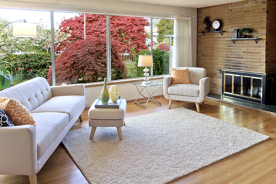Property Photo: Living room with fireplace 4752 Beach Dr SW  WA 98116 