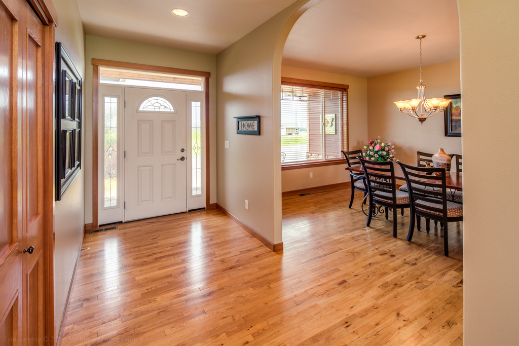 Property Photo: The wide welcoming entry with the formal dining room adjacent and all with oak hardwood flooring, and arched walkways. 6742 Family Hill Lane  WA 98248 